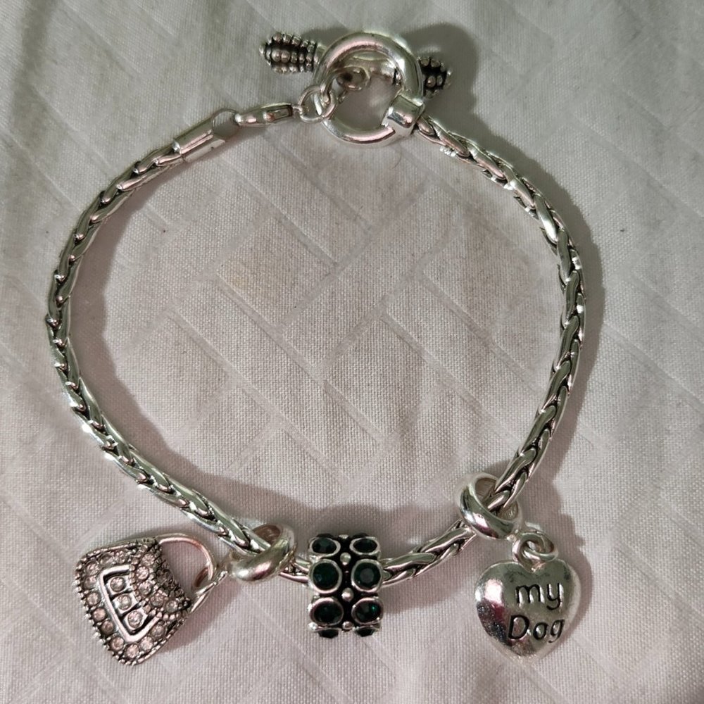 silver tone charm bracelet. 3 charms and bracelet , toggle charm